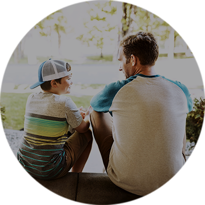 Vater und Sohn sitzen auf der Treppe und sprechen miteinander